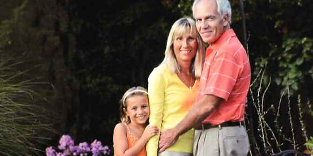 Karlene Novotny is pictured with her husband Steve, and their biological granddaughter Ava who they recently adopted.