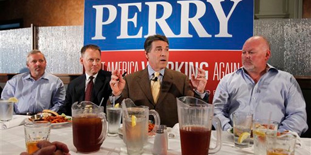Texas Gov. Rick Perry meets with business leaders at a lunch in Dubuque, Iowa, Aug. 16.
