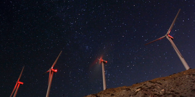A meteor (top L) speeds past windmills at the San Gregornio Pass Wind Farm near Whitewater, Calif., Aug. 13, 2015 during the annual Perseid meteor shower. (REUTERS/Sam Mircovich)
