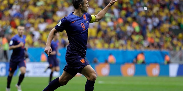 July 12, 2014: Netherlands' Robin van Persie celebrates after scoring his team's first goal on a penalty shot during the World Cup third-place soccer match between Brazil and the Netherlands at the Estadio Nacional in Brasilia, Brazil, Saturday, July 12, 2014. (AP)