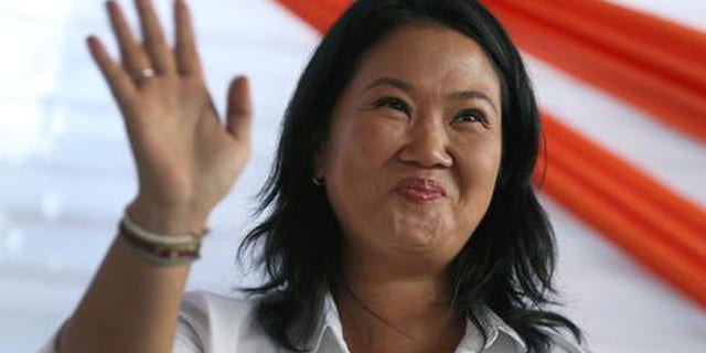 Presidential candidate Keiko Fujimori, center, of the "Fuerza Popular" political party, greets supporters as she campaigns in the San Juan de Lurigancho shantytown on the outskirts of Lima, Peru, Tuesday, May 10, 2016. On June 5, Keiko Fujimori will face Kuczynski in a runoff presidential election. (AP Photo/Martin Mejia)