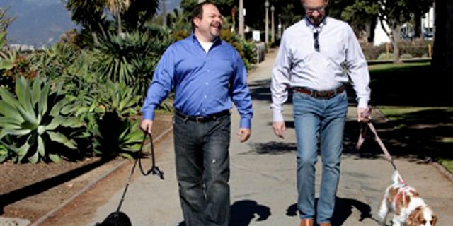 Feb. 23, 2012: This photo shows Steven May, right  walking with his dog, Winnie beside his attorney, David Pisarra, walking his dog, Dudley in Santa Monica, Calif.