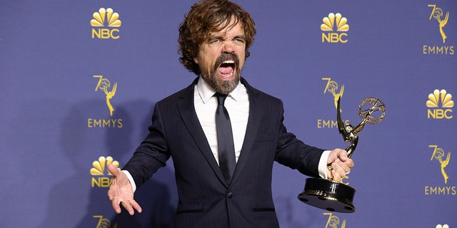 Peter Dinklage proudly holds his Emmy/