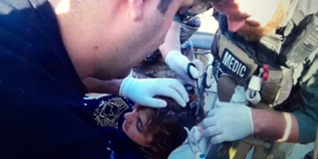 Medic Reed treats a young patient.