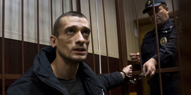 March 31, 2016: Russian artist Petr Pavlensky speaks to journalists as he sits in a cage in court room in Moscow, Russia.