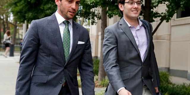 Former biotech CEO Martin Shkreli, right, leaves federal court with a member of his legal team.