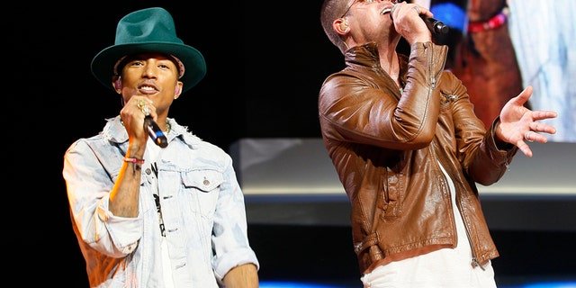 Singer Pharrell Williams (L) and singer Robin Thicke perform together at the Walmart annual shareholders meeting in Fayetteville, Arkansas June 6, 2014.