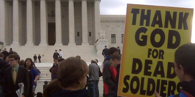 Oct. 6, 2010: Members of Westboro Baptist Church stand outside the U.S. Supreme Court as arguments are heard in the case of whether church members have a right to picket outside a marine's funeral.