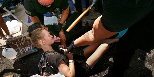 Police confront demonstrators outside the federal Immigration and Customs Enforcement agency on Thursday, July 5, 2018 in Philadelphia. Several protesters were arrested. (Jessica Griffin /The Philadelphia Inquirer via AP)