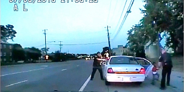 In this image made from July 6, 2016, video captured by a camera in the squad car of St. Anthony Police officer Jeronimo Yanez after shooting into the vehicle at Philando Castile during a traffic stop.