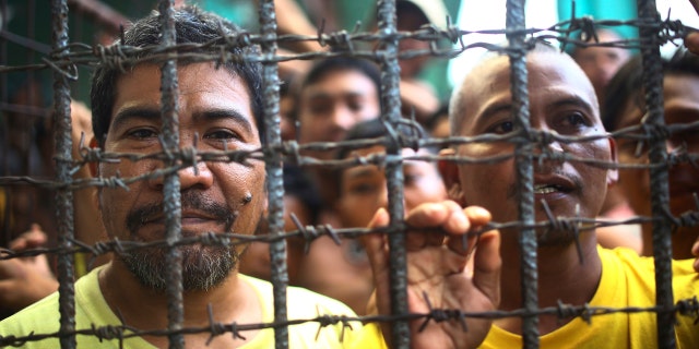Filipino inmates remain in their cell at the North Cotabato District Jail in Kidapawan city, Cotabato Province, southern Philippines, after a massive jailbreak Wednesday, Jan. 4, 2017.