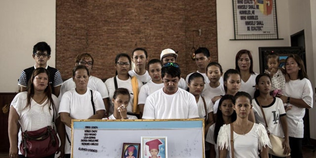 August 31, 2016: A family picture with the coffin of 5-year-old Danica mae Garcia who was killed in front of her family at their home in Dagupan City. An unidentifed gunman was targeting the young girl's grandfather.
