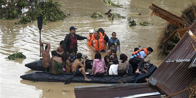 Dec. 17, 2011: Police rescue trapped residents following a flash flood that inundated Cagayan de Oro city, Philippines.
