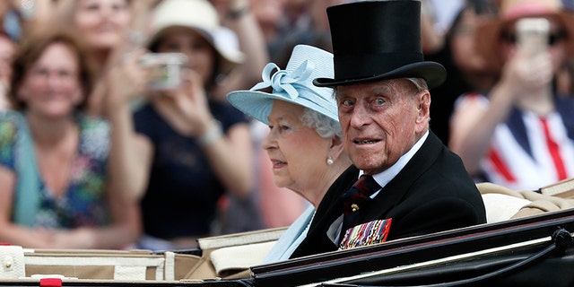 Britain's Queen Elizabeth II and Prince Philip return to Buckingham Palace in a carriage, after attending the annual Trooping the Color Ceremony, June 17, in London. Buckingham Palace said on Wednesday June 21, 2017, Prince Philip is good spirits after being admitted to hospital.