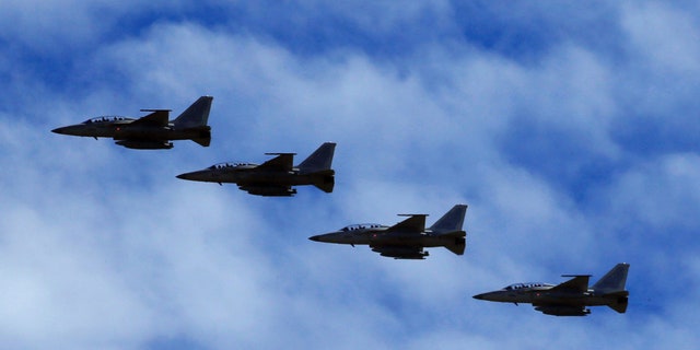 FA-50 fighter jets, newly purchased from South Korea, are escorted by fighter jets in the sky upon arrival in Clark air base, Angeles city, Pampanga province, north of Manila, Philippines December 1, 2016.  REUTERS/Romeo Ranoco - RTSU4O9