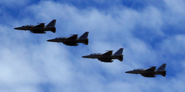 FA-50 fighter jets, newly purchased from South Korea, are escorted by fighter jets in the sky upon arrival in Clark air base, Angeles city, Pampanga province, north of Manila, Philippines December 1, 2016. REUTERS/Romeo Ranoco - RTSU4O9