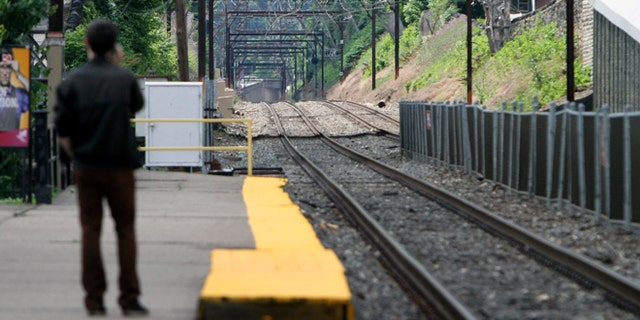 June 14, 2014: Unaware of the work stoppage Roy Pearson waits for a SEPTA commuter train at the East Falls commuter rail station in Philadelphia. (AP)