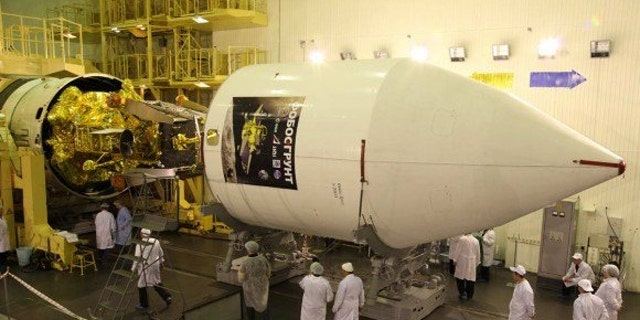 Phobos-Grunt and Yinghuo-1 spacecraft being encapsulated inside the nose cone for November 9 launch (Nov. 8 EST) to Mars and its tiny moon Phobos.