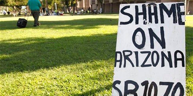 Signs set up by opponents of the Arizona immigration law are seen at the Arizona capitol July 26 in Phoenix. (AP Photo)