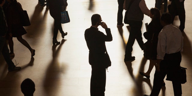 A man stands in the middle of Grand Central Terminal.