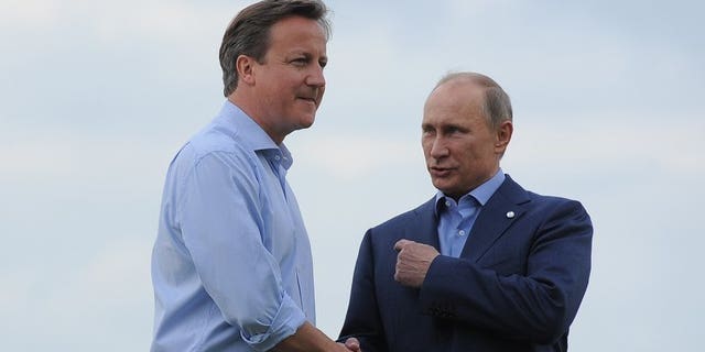 British Prime Minister David Cameron (L) greets Russia's President Vladimir Putin during the official arrrivals for the start of the G8 Summit at the Lough Erne resort near Enniskillen in Northern Ireland on June 17, 2013. UK officials said Russia risks isolation from the West if it does not sign up to action in Syria.