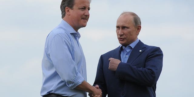 British Prime Minister David Cameron (L) greets Russia's President Vladimir Putin during the official arrrivals for the start of the G8 Summit at the Lough Erne resort near Enniskillen in Northern Ireland on June 17, 2013. UK officials said Russia risks isolation from the West if it does not sign up to action in Syria.