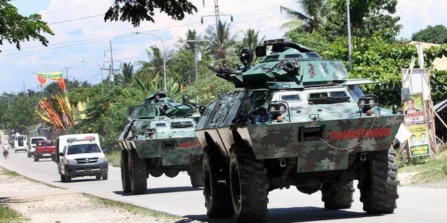 File picture taken on May 13, 2013 shows armored vehicles patrolling a highway on the southern Philippine island of Mindanao. Communist insurgents killed five civilians and kidnapped five soldiers on Mindanao on Tuesday in the latest of a series of violent acts following the collapse of peace talks, authorities said.