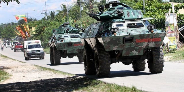 File picture taken on May 13, 2013 shows armored vehicles patrolling a highway on the southern Philippine island of Mindanao. Communist insurgents killed five civilians and kidnapped five soldiers on Mindanao on Tuesday in the latest of a series of violent acts following the collapse of peace talks, authorities said.