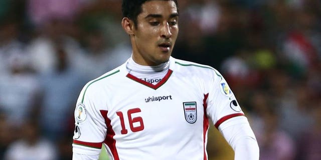 Iranian forward Reza Ghoochannejhad plays during a 2014 World Cup Asian zone match at Azadi Stadium in Tehran on June 11, 2013. Iran beat South Korea 1-0 to reach the 2014 World Cup but the hosts also qualified on goal difference despite a heroic effort by group rivals Uzbekistan.