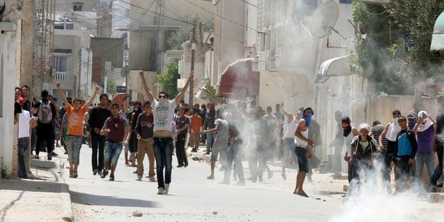 Tunisian police fire tear gas at radical Islamists in Ettadhamen, west of Tunis, in May. Six people belonging to Tunisia's hardline Salafist movement have each been handed five year jail sentences for torching an important Sufi shrine, the country's Sufi union said on Tuesday.