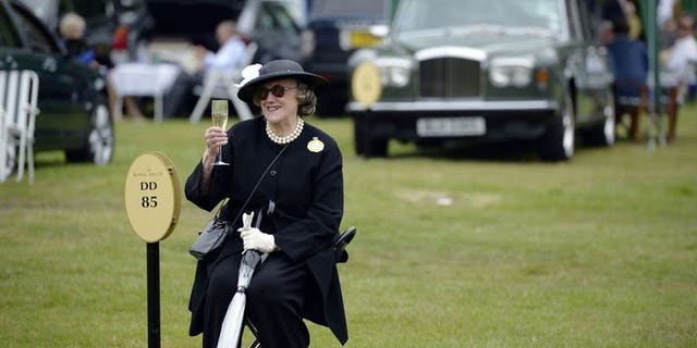 A racegoer raises a glass of champagne while she waits for friends during the first day of Royal Ascot, in Berkshire, west of London, on June 18, 2013. Ireland dominated the opening day of the Royal Ascot meeting on Tuesday carrying all before them in the first four races including the feature race the St James's Palace Stakes.