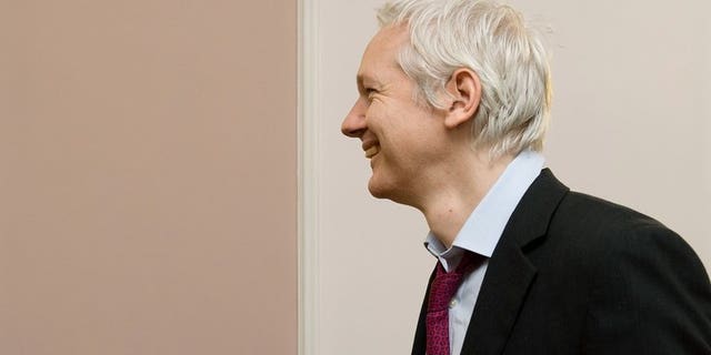 Wikileaks founder Julian Assange arrives for a photocall with French politician Jean Luc Melenchon inside the Ecuadorian embassy in central London, on December 6, 2012. A year after seeking refuge at the Ecuadorian embassy in London, Assange remains fearful of US "revenge" over the WikiLeaks disclosures and aware that the diplomatic deadlock over his case may continue for months, if not years.