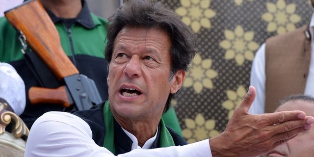 Cricket legend and chairman of Pakistan Tehreek-e-Insaaf (PTI) Imran Khan gestures as he attends a general election campaign meeting in Murree on April 29, 2013. Khan urged the government and military leaders to build a strategy to halt US drone attacks in the country's northwest as he was sworn into parliament.