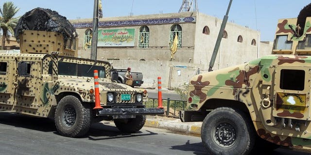 Iraqi military vehicles in front of a Shiite mosque in Baghdad on Tuesday following a suicide bombing. A suicide bomb attack in north Iraq on Wednesday killed the leader of a local political party and four relatives, officials said, on the eve of provincial elections his bloc was to participate in.