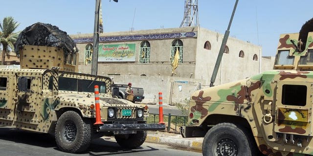 Iraqi military vehicles in front of a Shiite mosque in Baghdad on Tuesday following a suicide bombing. A suicide bomb attack in north Iraq on Wednesday killed the leader of a local political party and four relatives, officials said, on the eve of provincial elections his bloc was to participate in.