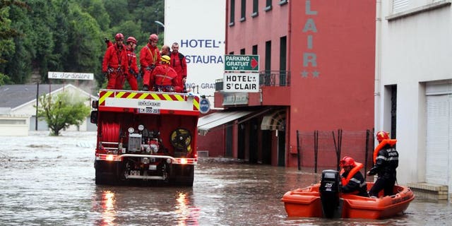 Firemen are at work in Lourdes where the Gave de Pau, the river passing through the town, flooded some pilgrimage areas on June 18, 2013. Flash floods in southwestern France killed an elderly woman as the inundated grotto at the Roman Catholic pilgrimage site of Lourdes remained closed for a second day