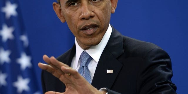 Barack Obama at a press conference in the Chancellery in Berlin on Wednesday. The US president refused to specify the exact nature of new US military aid to Syrian rebels, despite signals from top US officials that they will be get small arms and ammunition.