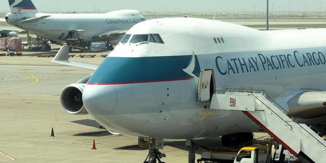 Cathay Pacific cargo planes are being loaded in Hong Kong, on October 20, 2002. Hong Kong flagship carrier said on Friday it will pay Can$1.5 million ($1.45 million) to Canadian authorities to settle an air cargo price-fixing case.