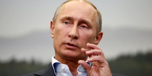 Russian President Vladimir Putin speaks during a press conference at the end of the G8 summit in Enniskillen, Northern Ireland, on June 18, 2013. Putin says he has no recollection of allegedly stealing the Super Bowl ring belonging to the National Football League's New England Patriots owner Robert Kraft.