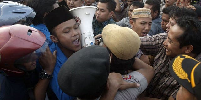 Demonstrators tussle with police during a protest against the impending oil price increase in Surabaya city in eastern Java island on June 21, 2013. Indonesia on Friday announced the first hike in fuel prices since 2008 despite violent protests against the unpopular measure, as Southeast Asia's top economy seeks to reduce crippling subsidies.