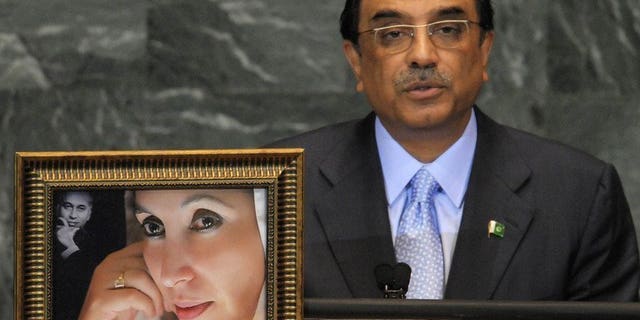 Pakistani President Asif Ali Zardari speaks next to a portrait of his late wife, Benazir Bhutto in New York on September 25, 2009. Swiss prosecutors announced Friday that they had refused to reopen a probe into alleged corruption in the 1990s by current Zardari and his late wife Benazir Bhutto.