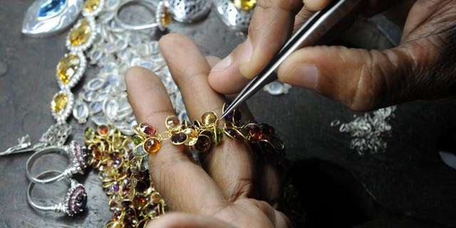 A Sri Lankan worker crafts gold jewellery in the southern city of Galle on January 20, 2011. Sri Lanka announced a 10 percent tax on gold imports Friday in what observers said was a bid to curb smuggling to India as global markets trading in the precious metal reported sharp price drops to 2010 levels.