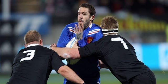 Remi Tales of France (centre) is tackled by Sam Cane (left) and Owen Franks (right) of New Zealand during the third France vs New Zealand rugby union Test match, in New Plymouth on June 21, 2013. The All Blacks beat France 24-9.