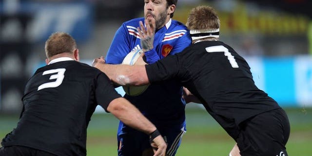 Remi Tales of France (centre) is tackled by Sam Cane (left) and Owen Franks (right) of New Zealand during the third France vs New Zealand rugby union Test match, in New Plymouth on June 21, 2013. The All Blacks beat France 24-9.