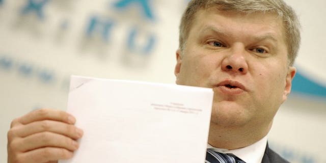 The Yabloko opposition party leader Sergei Mitrokhin speaks during a press conference in Moscow, on January 16, 2012. The head of a top Russian rights group and Mitrokhin say they been assaulted by riot police during a night-time raid on the non-profit group in the latest crackdown on activists during Vladimir Putin's new term.