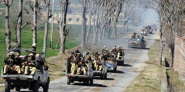 Pakistani soldiers ride on trucks in the remote Bajaur Agency, on February 28, 2009. A bomb explosion has killed two members of a Pakistani pro-government militia in a tribal region near the Afghanistan border.