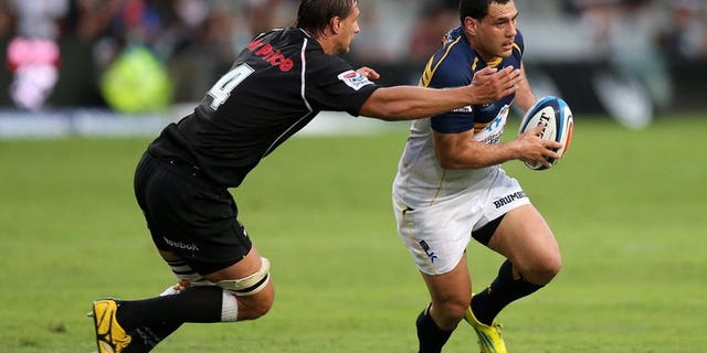 George Smith of the Brumbies (R) is tackled by Anton Bressler of the Sharks on March 16, 2013. The injury-hit Wallabies called up veteran flanker Smith among three reinforcements for the squad for next weekend's make-or-break Test with the British and Irish Lions.