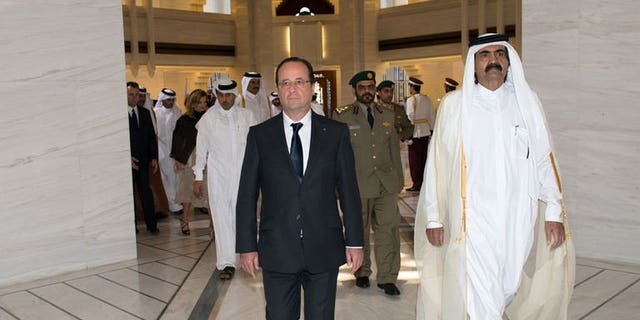 French President Francois Hollande (left) is greeted by Qatari Emir Sheikh Hamad bin Khalifa al-Thani at the Emiri Diwan in Doha, on June 23, 2013. Hollande has urged rebels in Syria to "retake" zones that have fallen into the hands of extremist Islamist groups.
