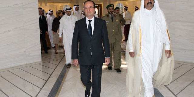 French President Francois Hollande (left) is greeted by Qatari Emir Sheikh Hamad bin Khalifa al-Thani at the Emiri Diwan in Doha, on June 23, 2013. Hollande has urged rebels in Syria to "retake" zones that have fallen into the hands of extremist Islamist groups.