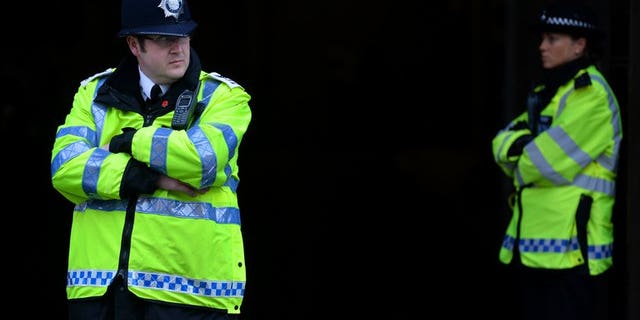 British police officers stand in position at Westminster Magistrates court in central London on May 30, 2013. British police on Sunday said that a suspicious item found outside a mosque in central England, which led to 150 local residents being evacuated, was a small home-made explosive device.